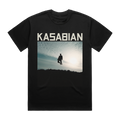 Front-facing view of a black, short-sleeve unisex T-shirt featuring the band name Kasabian in bold white lettering, with “Hippie Sunshine” artwork printed prominently across the chest.